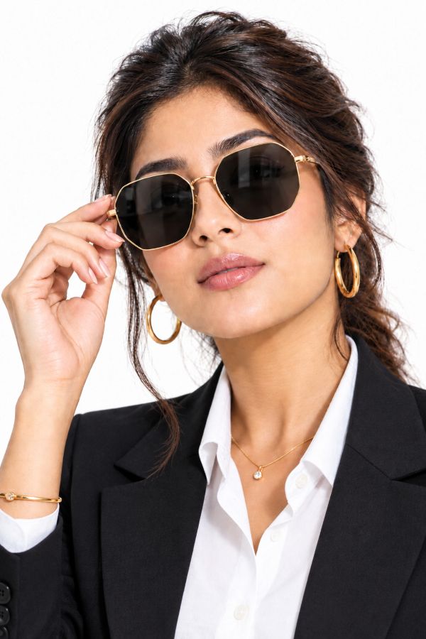 Woman wearing elegant gold-frame Jude Eyewear sunglasses.